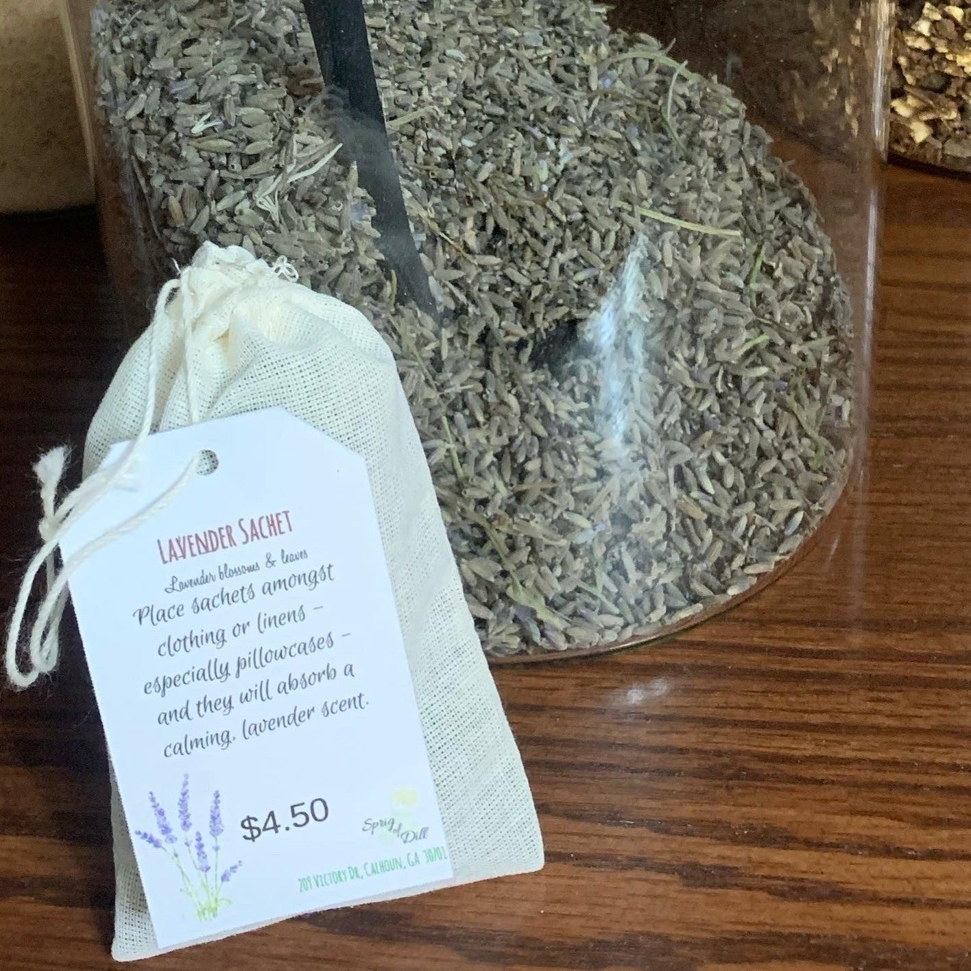 Sachet of Lavender in front of jar of lavender buds.