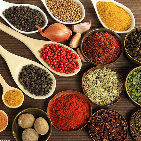 Spoons and small bowls of ingredients that make up Lebanese Za'atar.